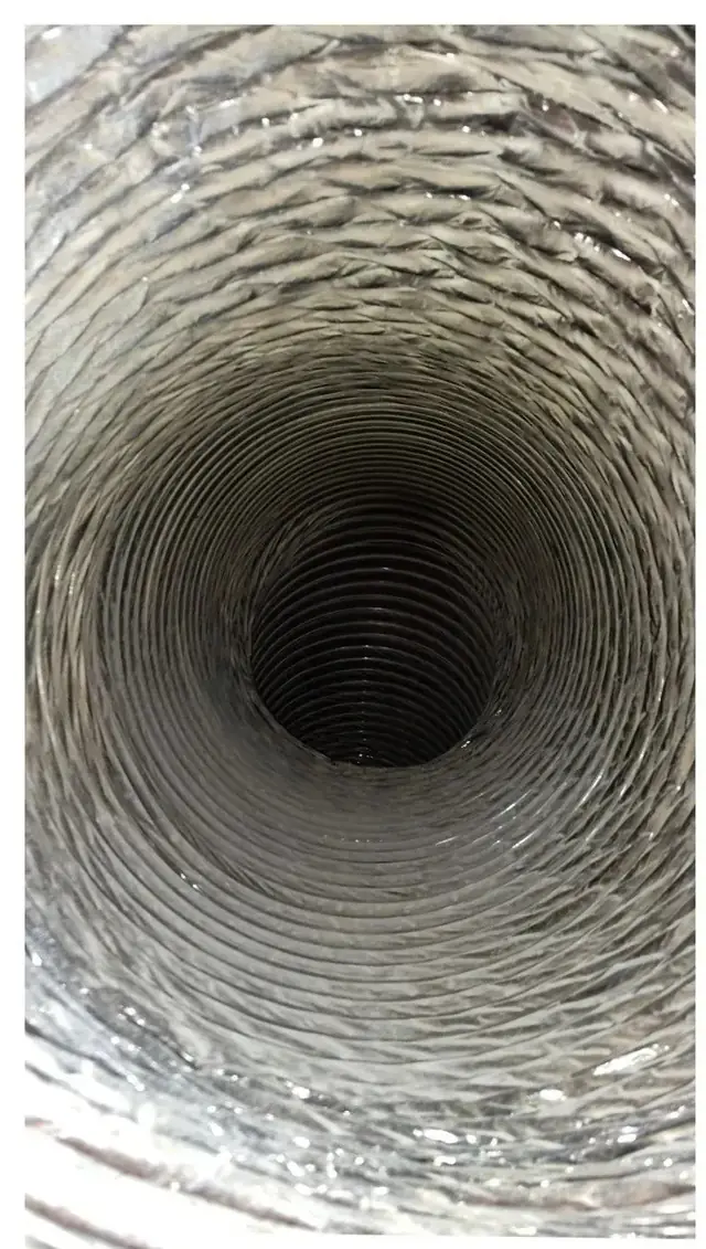 Inside a round flex duct after the sweep, foil showing again